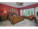 Spacious main bedroom with a large bay window and a ceiling fan at 19212 N Tallowood Way, Surprise, AZ 85387