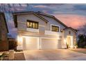 Elegant two-story home featuring a spacious three-car garage and a welcoming entrance at dusk at 2046 E Avenida Del Sol --, Phoenix, AZ 85024