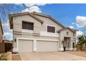 Inviting two-story home featuring a three-car garage and a well-maintained yard under a bright sky at 2046 E Avenida Del Sol --, Phoenix, AZ 85024