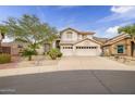Charming two-story home with a three-car garage and desert landscaping at 22043 N 59Th Dr, Glendale, AZ 85310