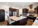 Gourmet kitchen with a large island, stainless steel appliances, and custom cabinets at 22043 N 59Th Dr, Glendale, AZ 85310