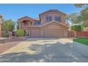 Spacious two-story home with a three car garage, landscaped yard and American flag at 25767 N 67Th Dr, Peoria, AZ 85383