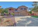 Spacious two-story home with a three car garage, landscaped yard and American flag at 25767 N 67Th Dr, Peoria, AZ 85383
