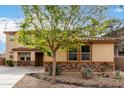 Charming two-story home with decorative stone accents and a low-maintenance landscaped front yard at 27071 N 172Nd Ln, Surprise, AZ 85387