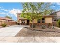 Charming two-story home with decorative stone accents and a low-maintenance landscaped front yard at 27071 N 172Nd Ln, Surprise, AZ 85387