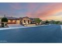 Street view of a single-Gathering home at sunset with manicured desert landscaping and a brick paved driveway at 28834 N 68Th Ave, Peoria, AZ 85383
