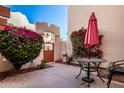 Private courtyard with an umbrella table set next to colorful bougainvillea and a gated entryway, a perfect outdoor retreat at 333 N Pennington Dr # 15, Chandler, AZ 85224