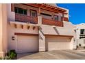 Southwestern-style home with a balcony featuring decorative railing and a two-car garage, blending charm and convenience at 333 N Pennington Dr # 15, Chandler, AZ 85224