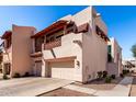 Southwestern-style home with a balcony featuring decorative railing and a two-car garage, providing charm and convenience at 333 N Pennington Dr # 15, Chandler, AZ 85224