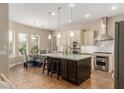 Bright kitchen features an island with seating, stainless steel appliances and pendant lighting at 3353 E Nolan Dr, Chandler, AZ 85249