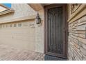 Inviting entryway features a decorative security door, stone accents and two car garage at 3471 E Azalea Dr, Gilbert, AZ 85298