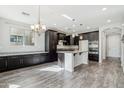 Open-concept kitchen featuring dark cabinets, granite countertops, and stainless steel appliances at 3471 E Azalea Dr, Gilbert, AZ 85298