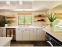 Bright kitchen featuring white cabinets, modern appliances, and a large window with a view of the outdoors at 37801 N Cave Creek Rd # 11, Cave Creek, AZ 85331