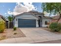 Lovely home with a two-car garage, manicured front yard with desert landscaping and an arched entry way at 3847 W Yellow Peak Dr, San Tan Valley, AZ 85144