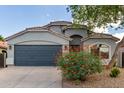 Charming single-story home with a two-car garage and a well-manicured front yard with desert landscaping at 3847 W Yellow Peak Dr, San Tan Valley, AZ 85144