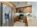 Well-equipped kitchen with stainless steel appliances and wooden cabinets at 3935 E Rough Rider Rd # 1264, Phoenix, AZ 85050