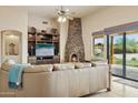 Cozy living room featuring a stone fireplace and lots of natural light at 40627 N 6Th Ave, Phoenix, AZ 85086