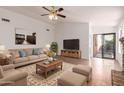 Comfortable living room with plush beige sofa, stylish rug, and modern entertainment center at 4450 E Amberwood Dr, Phoenix, AZ 85048