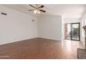 The open living room features wood-look tile flooring and a sliding glass door at 4450 E Amberwood Dr, Phoenix, AZ 85048