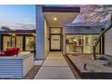 Elegant modern home featuring a well-lit entryway, desert landscaping, and contemporary architecture at 5033 E Turquoise Ave, Paradise Valley, AZ 85253