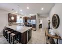 Kitchen with dark cabinets, stainless appliances, bar stool seating and adjacent living spaces at 5450 E Deer Valley Dr # 1186, Phoenix, AZ 85054