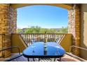 Balcony with a table and chairs, offering a view of the surrounding landscape and clear blue sky at 5450 E Deer Valley Dr # 2023, Phoenix, AZ 85054