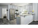 Kitchen with stainless steel appliances, granite countertops, breakfast bar, and tile flooring at 5450 E Deer Valley Dr # 2023, Phoenix, AZ 85054