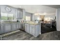 Open concept kitchen with stainless steel appliances, granite countertops, and wood-look tile flooring at 5450 E Deer Valley Dr # 2023, Phoenix, AZ 85054