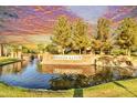 Scenic Fulton Ranch entrance with brick signage, water feature, mature trees, and vibrant sunset at 560 W Powell Way, Chandler, AZ 85248