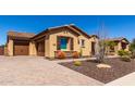 Attractive single-story home boasting a three-car garage, desert landscaping, and a brick-paved driveway at 6112 E Calle De Pompas --, Cave Creek, AZ 85331