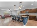 Bright kitchen featuring stainless steel appliances, wood cabinets and a large center island at 696 W Glen Canyon Dr, San Tan Valley, AZ 85140
