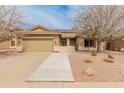 Inviting single-story home with desert landscaping, a tile roof, and walkway leading to a covered porch at 760 W Douglas Ave, Gilbert, AZ 85233