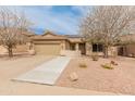 Inviting single-story home with desert landscaping, a tile roof, and walkway leading to a covered porch at 760 W Douglas Ave, Gilbert, AZ 85233