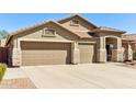 The home features a spacious three car garage and a large driveway at 8014 W Ross Ave, Peoria, AZ 85382