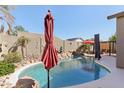 Resort style pool in landscaped yard featuring a rock waterfall feature at 8014 W Ross Ave, Peoria, AZ 85382