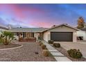 Charming single-story home boasting a well-manicured front yard, two-car garage, and inviting curb appeal at 8738 E Rose Ln, Scottsdale, AZ 85250