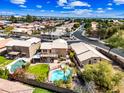 Expansive aerial view showcasing the home's backyard pool, surrounding neighborhood, and desert landscape at 9364 S Margo Dr, Tempe, AZ 85284