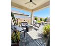 Relaxing covered patio with comfortable seating, a cozy fire pit, and stylish outdoor décor at 14153 W Surrey Dr, Surprise, AZ 85379