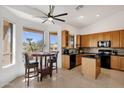 Bright kitchen with granite countertops, black appliances, and a breakfast nook overlooking the backyard at 16113 E Andrew Dr, Fountain Hills, AZ 85268