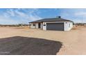 An elevated view of the house shows the desert landscaping and two car garage at 16567 N Slate Ln, Maricopa, AZ 85139