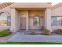 Close-up of a well-kept front porch with neutral colors and decorative plants that are eye-catching at 1681 S Granite St, Gilbert, AZ 85295