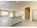 Spacious open kitchen with ample cabinetry and central island flowing into the living area at 1681 S Granite St, Gilbert, AZ 85295