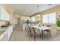 Bright, open kitchen featuring white cabinetry, a marble dining table, and stainless steel appliances at 1681 S Granite St, Gilbert, AZ 85295
