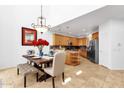 Dining area showcases stylish light fixture, chairs, and view into the open kitchen at 17025 E La Montana Dr # 123, Fountain Hills, AZ 85268