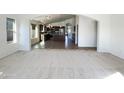Bright, open-concept living area with sightlines to the kitchen and dining area at 17494 N Maddaloni Ave, Maricopa, AZ 85138