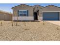 Single-story home featuring a desert-landscaped front yard, blue garage door, and shutters at 17621 W Pierson St, Goodyear, AZ 85395