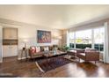 Bright living room boasts wood floors, a large picture window, and modern furnishings at 1939 E Solano Dr, Phoenix, AZ 85016