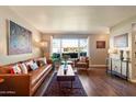Bright living room boasts wood floors, a large picture window, and modern furnishings at 1939 E Solano Dr, Phoenix, AZ 85016