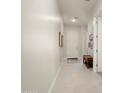 Bright and airy foyer featuring neutral walls, tile flooring, a bench, and access to other rooms at 21387 W Meadowbrook Ave, Buckeye, AZ 85396