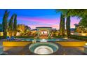 Sparkling pool and hot tub with covered outdoor seating area, lush landscaping, and mature trees at 2174 E Avenida Del Valle Ct, Gilbert, AZ 85298